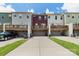 Exterior view showcasing townhomes with garages and wooden decks at 4060 Zilker Park Dr, Charlotte, NC 28217