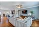 Open concept living room with hardwood floors, ceiling fan, comfortable couch, and decor at 4060 Zilker Park Dr, Charlotte, NC 28217