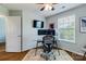 Modern home office with a glass desk, comfortable chair, and natural light at 4060 Zilker Park Dr, Charlotte, NC 28217