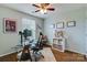 Bright office features a modern glass desk, ceiling fan, and light gray walls at 4060 Zilker Park Dr, Charlotte, NC 28217