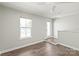 Bright bedroom with wood floors, a window, and glass door leading to outdoor space at 420 E 16Th St, Charlotte, NC 28206