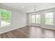 Bright bedroom with hardwood floors, a ceiling fan, and three large windows at 420 E 16Th St, Charlotte, NC 28206