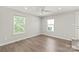 Well-lit bedroom with hardwood floors, two windows, and ceiling fan at 420 E 16Th St, Charlotte, NC 28206