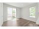 Bright bedroom with hardwood floors, large window and sliding glass door to outdoor patio at 420 E 16Th St, Charlotte, NC 28206