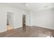 Bedroom featuring hardwood floors, two doorways, and natural light from the window at 420 E 16Th St, Charlotte, NC 28206