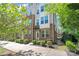 Modern townhome with brick facade, white accents, tidy landscaping, and visible balcony at 420 E 16Th St, Charlotte, NC 28206