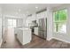 Bright kitchen with stainless steel appliances, white cabinetry, and island with bar seating at 420 E 16Th St, Charlotte, NC 28206