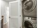 Conveniently located laundry closet with stacked washer and dryer units and a louvered door at 420 E 16Th St, Charlotte, NC 28206