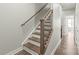 Elegant staircase with wood treads, white risers, and dark metal spindles leading to upper level at 420 E 16Th St, Charlotte, NC 28206