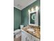 Charming powder room with granite countertop, decorative mirror, and modern fixtures at 4407 Beauvista Dr, Charlotte, NC 28269