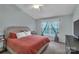 Comfortable bedroom with neutral tones, plush bedding, and large window at 4407 Beauvista Dr, Charlotte, NC 28269