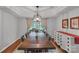Elegant dining room featuring a dark wood table, stylish chandelier, and traditional decor at 4407 Beauvista Dr, Charlotte, NC 28269