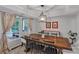 Bright dining room with a large wooden table, elegant chandelier, and views of the outdoors at 4407 Beauvista Dr, Charlotte, NC 28269