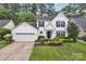 Charming two-story home featuring a landscaped front yard, attached garage, and classic white siding with black shutters at 4407 Beauvista Dr, Charlotte, NC 28269