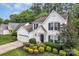 Charming two-story home featuring a landscaped front yard, attached garage, and classic white siding with black shutters at 4407 Beauvista Dr, Charlotte, NC 28269