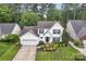 Beautifully landscaped front yard showcasing a two-story home with white siding and a two-car attached garage at 4407 Beauvista Dr, Charlotte, NC 28269