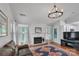 Warm living room with a fireplace, hardwood floors, and ample seating at 4407 Beauvista Dr, Charlotte, NC 28269