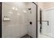 Sleek bathroom shower with white subway tile, glass enclosure, and matte black fixtures at 4520 Radler Ct, Charlotte, NC 28217