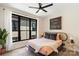 Stylish bedroom boasts a modern ceiling fan, a large window and a unique rattan headboard at 4520 Radler Ct, Charlotte, NC 28217
