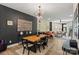 Open dining area with modern lighting and seamless flow to the living spaces at 4520 Radler Ct, Charlotte, NC 28217