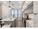 Bright kitchen showcasing stainless appliances, a center island with seating, and hardwood flooring at 4520 Radler Ct, Charlotte, NC 28217