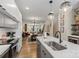Open concept kitchen features stainless steel appliances, quartz countertops, and an adjacent living area at 4520 Radler Ct, Charlotte, NC 28217