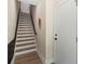 Well-lit staircase with wood treads, modern railing, and neutral walls leading to the upper levels of the home at 4520 Radler Ct, Charlotte, NC 28217