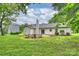 Large backyard with a fire pit and seating area, surrounded by lush greenery at 4633 Cringle Ct, Charlotte, NC 28226
