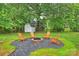 Inviting backyard space with a fire pit, chairs, landscaping, and storage shed at 4633 Cringle Ct, Charlotte, NC 28226