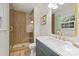 Elegant bathroom with a glass-enclosed shower, marble countertop, and modern gold fixtures at 4633 Cringle Ct, Charlotte, NC 28226