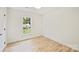 Bright bedroom with hardwood floors and white walls showcasing a large window and natural light at 4633 Cringle Ct, Charlotte, NC 28226