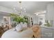 Open-concept dining area with stylish chandelier and greenery at 4633 Cringle Ct, Charlotte, NC 28226