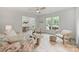 Bright living room with a ceiling fan, natural light, and view into dining area at 4633 Cringle Ct, Charlotte, NC 28226