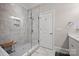Modern bathroom features a glass shower with a seat, bright lighting, and neutral tile at 5118 Waldron Meadow Dr, Charlotte, NC 28226