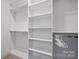 Empty walk-in closet with custom shelving and hanging rods for optimal organization at 5118 Waldron Meadow Dr, Charlotte, NC 28226