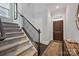 Welcoming entryway with staircase, dark wood flooring, and a decorative area rug leading to a wooden door at 5118 Waldron Meadow Dr, Charlotte, NC 28226
