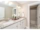 This renovated bathroom features granite countertops, dual sinks, large mirror, and neutral colors at 517 E Main St, Rock Hill, SC 29730