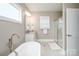 This bathroom has a soaking tub, separate shower, vanity with granite top and nice mirror at 517 E Main St, Rock Hill, SC 29730