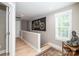 This hallway is freshly painted with white trim, a striking art piece and natural light at 517 E Main St, Rock Hill, SC 29730
