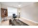 This naturally lit home office has a ceiling fan, artwork, and neutral colors at 517 E Main St, Rock Hill, SC 29730