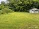 Well-maintained lawn with detached garage offering potential for workshop or storage at 6561 Weldon Nw Cir, Concord, NC 28027