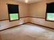 Bright bedroom featuring neutral walls, carpet flooring, and windows that provide lots of natural light and serene views at 6561 Weldon Nw Cir, Concord, NC 28027