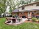 An outdoor patio area includes a grill and dining table, perfect for enjoying time in the landscaped backyard at 6941 Queensberry Dr, Charlotte, NC 28226