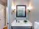 Neutral bathroom featuring decorative sconces flanking an ornate mirror and a white vanity at 6941 Queensberry Dr, Charlotte, NC 28226