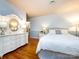 Bedroom with a white dresser, a white nightstand, and a bed with an upholstered headboard at 6941 Queensberry Dr, Charlotte, NC 28226