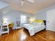 Bedroom featuring hardwood floors, a ceiling fan, and two windows at 6941 Queensberry Dr, Charlotte, NC 28226