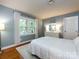 Bedroom with a white bed, hardwood floors, a white dresser, and a neutral rug at 6941 Queensberry Dr, Charlotte, NC 28226