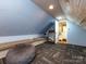 Bonus room with a long bench, bean bag, and carpet flooring at 6941 Queensberry Dr, Charlotte, NC 28226