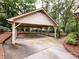 Spacious carport with ample parking and a charming, natural setting with mature trees at 6941 Queensberry Dr, Charlotte, NC 28226