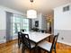 Bright dining room with hardwood floors, modern lighting, and a view of the outdoors at 6941 Queensberry Dr, Charlotte, NC 28226